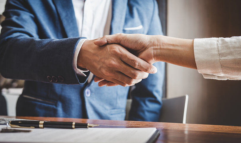 Estate agent shaking hands with a client.
