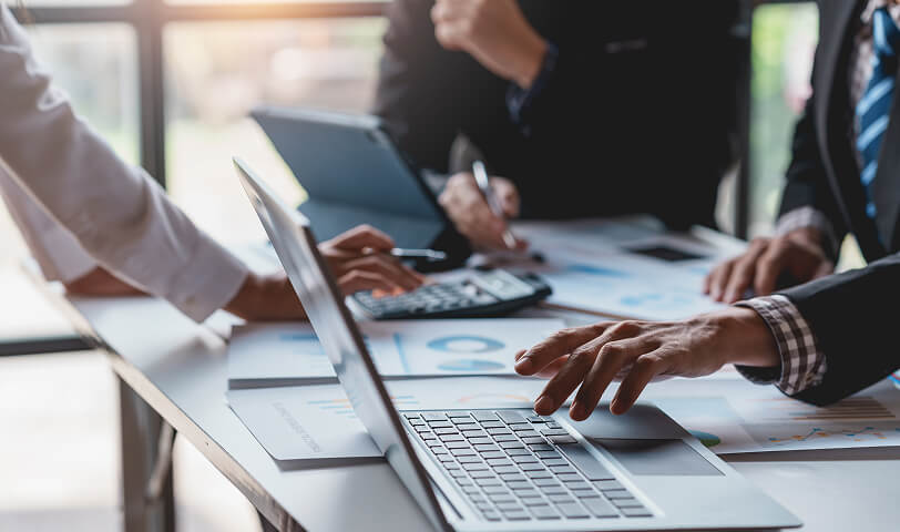 Estate agents working together at a desk.