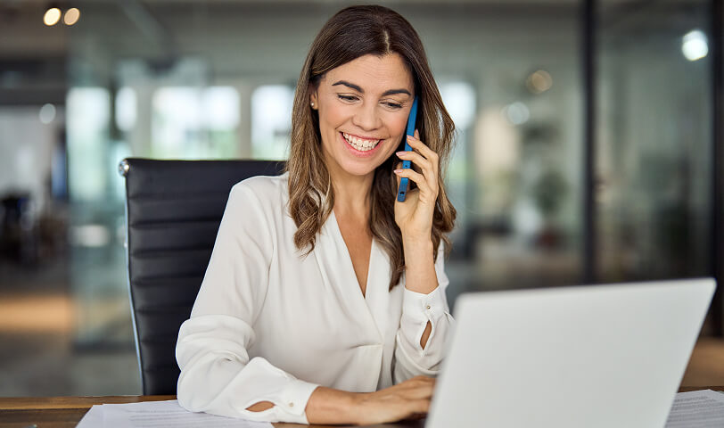 Estate agent speaking on the phone with a client.