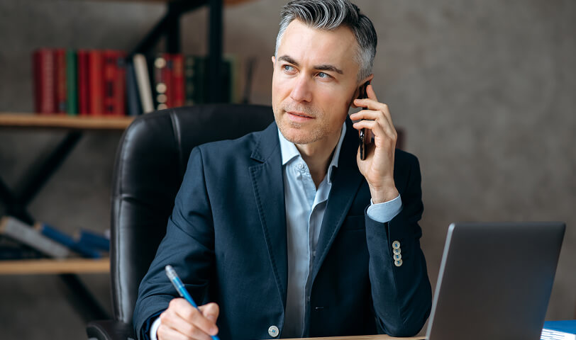 Estate agent talking on the phone with a tenant.