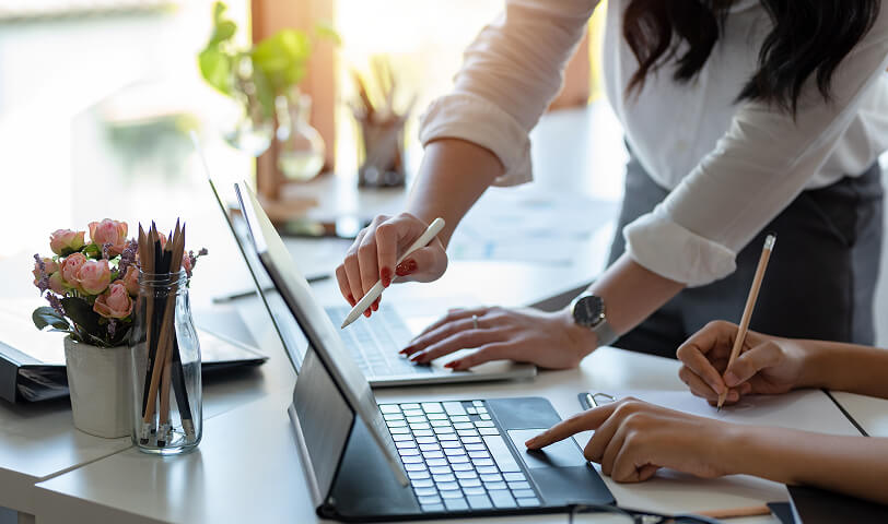 Estate agents preparing marketing materials for property promotion.