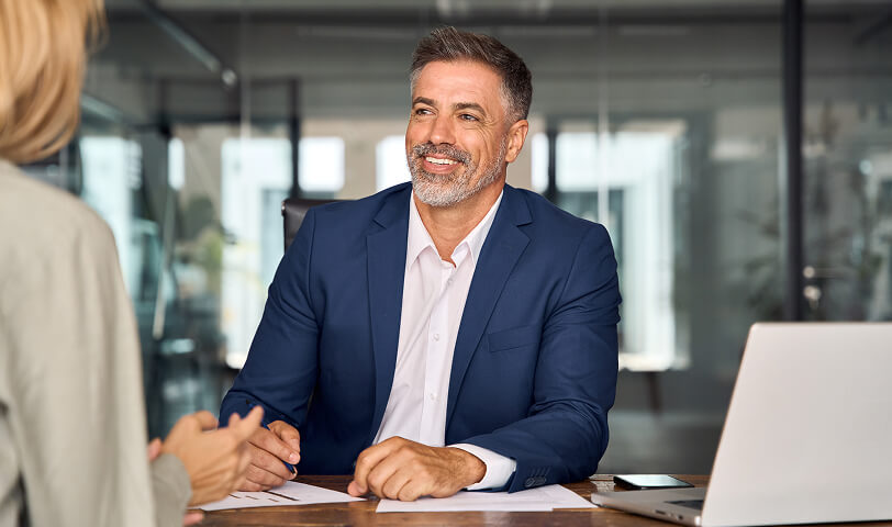 Smiling estate expert talking to client.