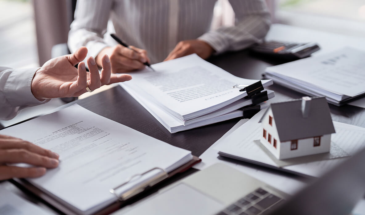Estate agent signing documents.