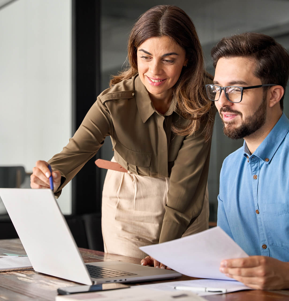 Female and male estate agents collaborating in a modern office.